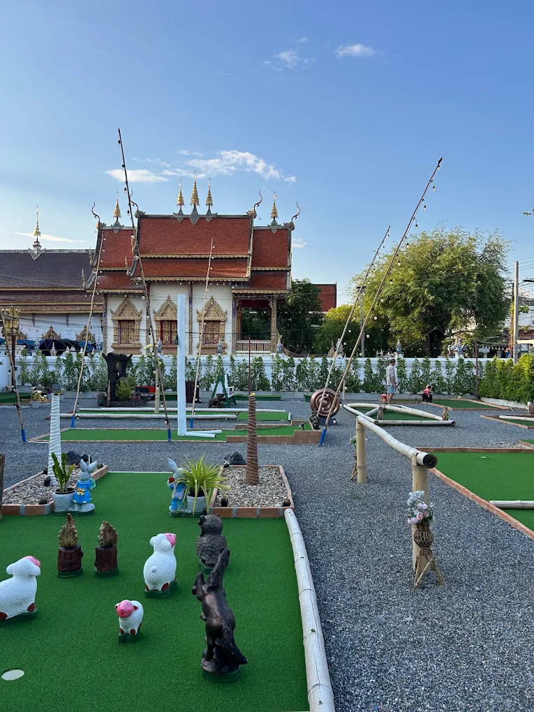 Bamboo Balls mini golf course with a Chiang Mai temple beyond the green